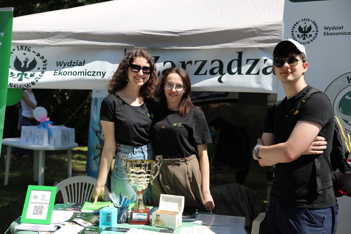 There are three students standing in front of the tent during SGGW Days.